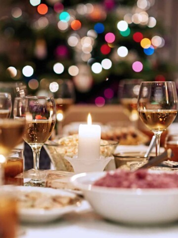wine glasses and appetizers at a christmas wine party with a christmas tree