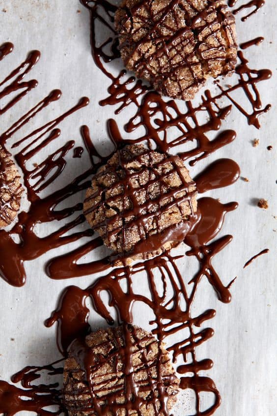 A twist on the classic Peanut Blossom Cookies, these Vegan Peanut Butter Espresso Cookies are rich, crunchy and delicious. Vegan peanut butter and espresso cookies are drizzled with a chocolate espresso glaze that makes the cookies sing!