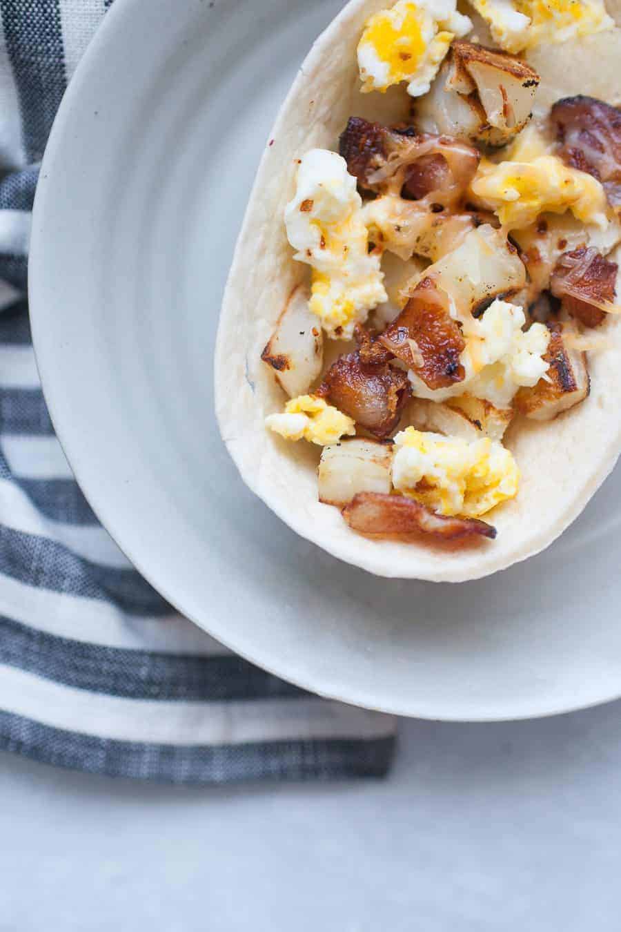 These bacon breakfast scramble bowls are the perfect way to start the weekend! Customize these bowls with your favorite breakfast protein, veggies, and toppings like cheese, green chile or salsa. Or keep them simple with potatoes, eggs and bacon! Either way, these breakfast bowls are sure to be a hit with your family. 