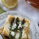 A stack of asparagus and ricotta tarts on a plate.