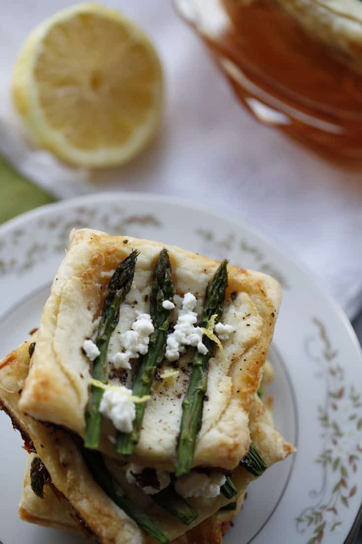 A stack of asparagus and ricotta tarts on a plate.