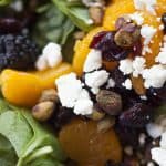 A plate of spinach and berries.