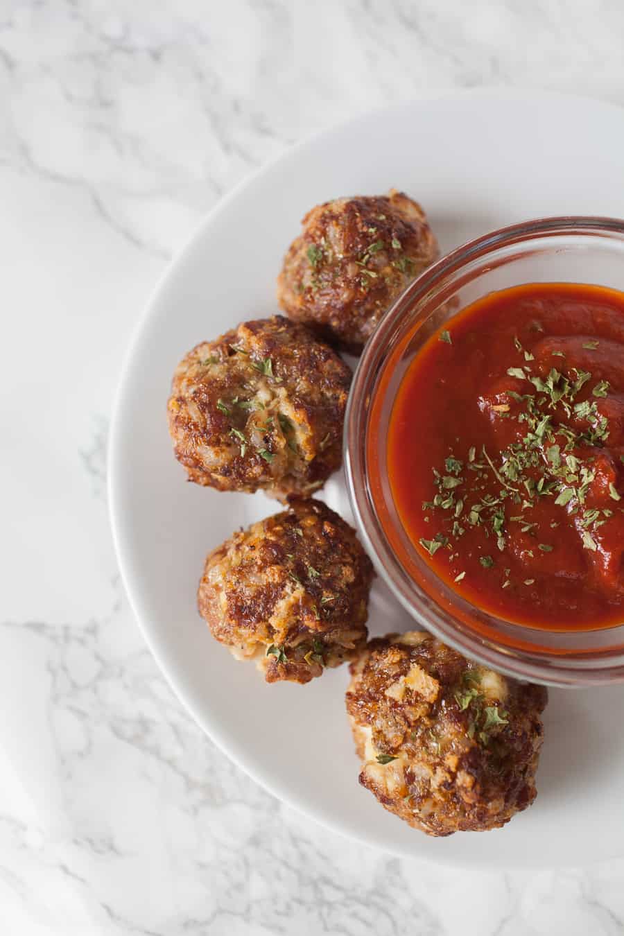 Looking for a quick and easy appetizer for the Big Game? These ricotta stuffed sausage meatballs are so easy to make. Your football friends will go wild for these quick baked ricotta stuffed sausage meatballs at your Big Game party! party food | meatballs from scratch | meatball recipes | meatballs | appetizer recipes | superbowl party food | football food