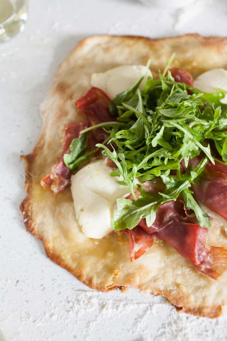 Overhead photo of pizza topped with arugula.