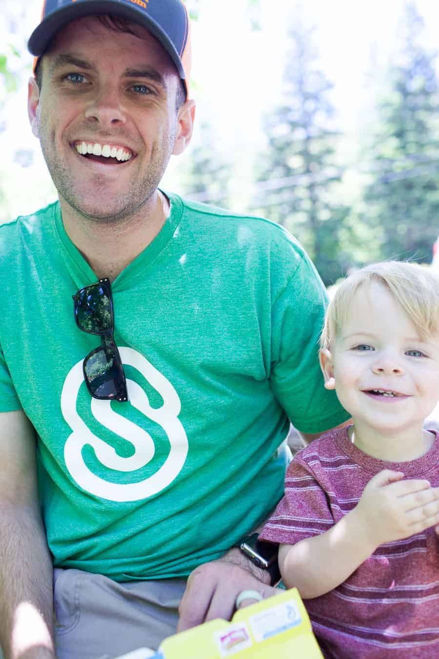 Making Memories with a Toddler - A man and a child smiling while holding a box of cookies.