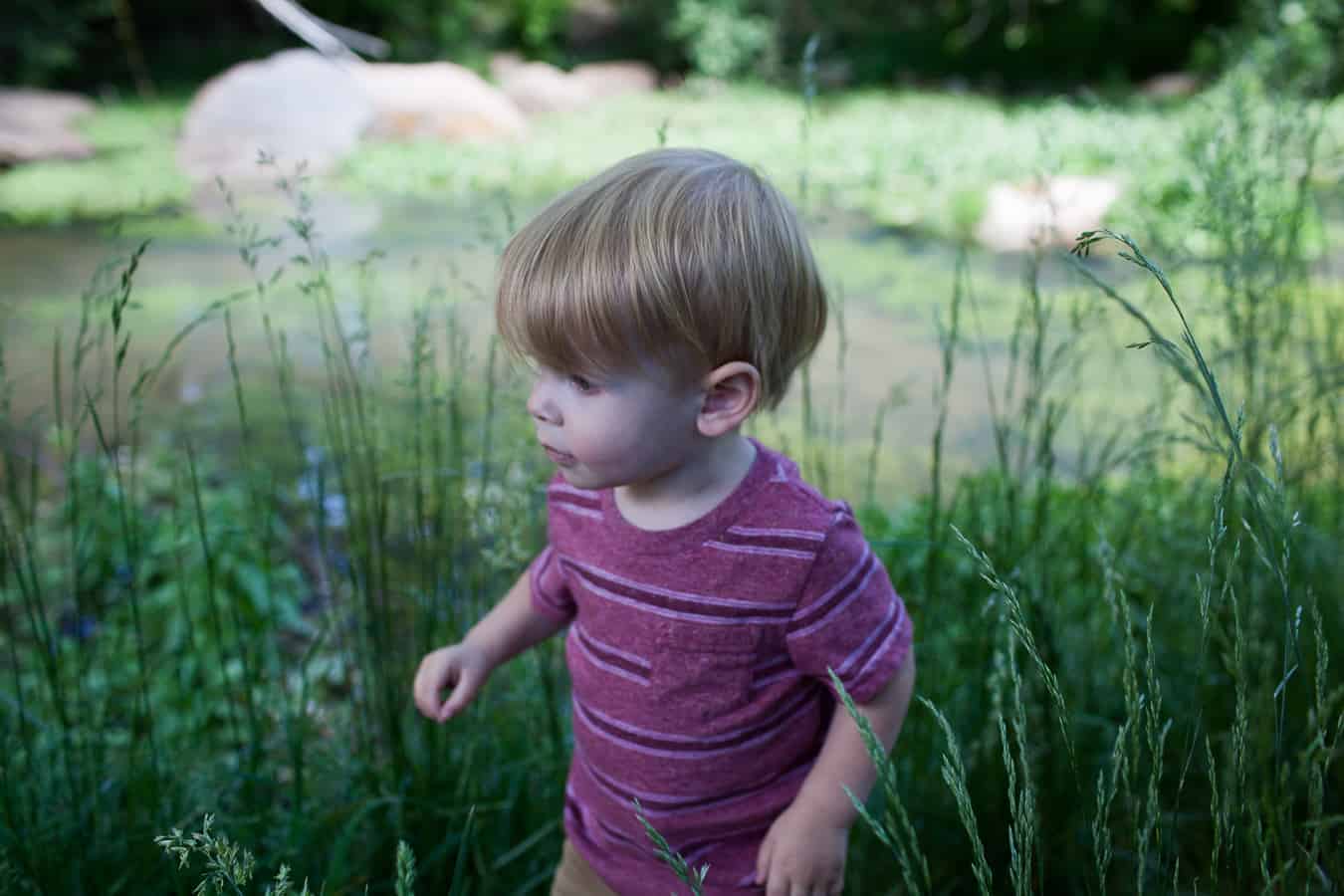 Making memories with a young boy near a pond.