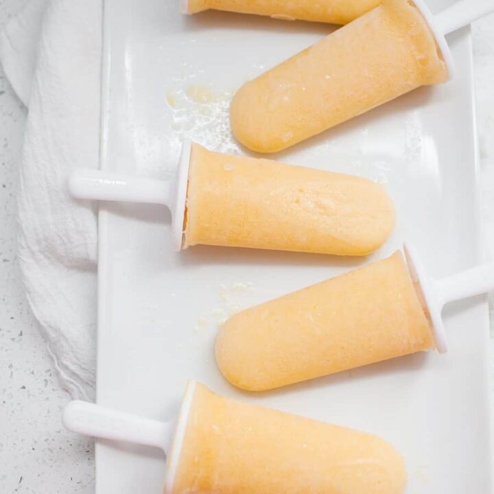 These healthy peach lemonade popsicles are the perfect summer treat! Cool down with these refined sugar free, creamy, fruity pops.