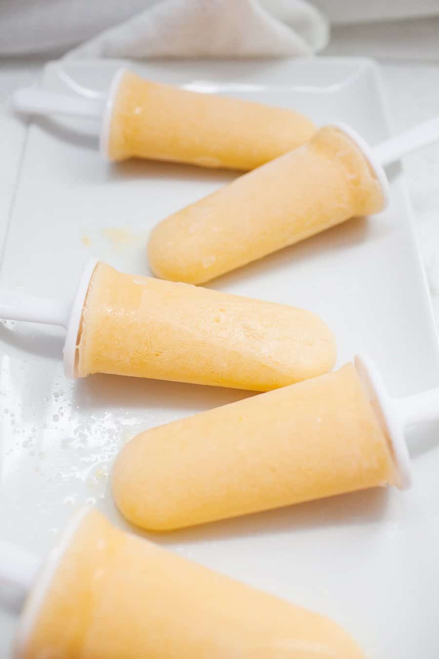 These healthy peach lemonade popsicles are the perfect summer treat! Cool down with these refined sugar free, creamy, fruity pops.