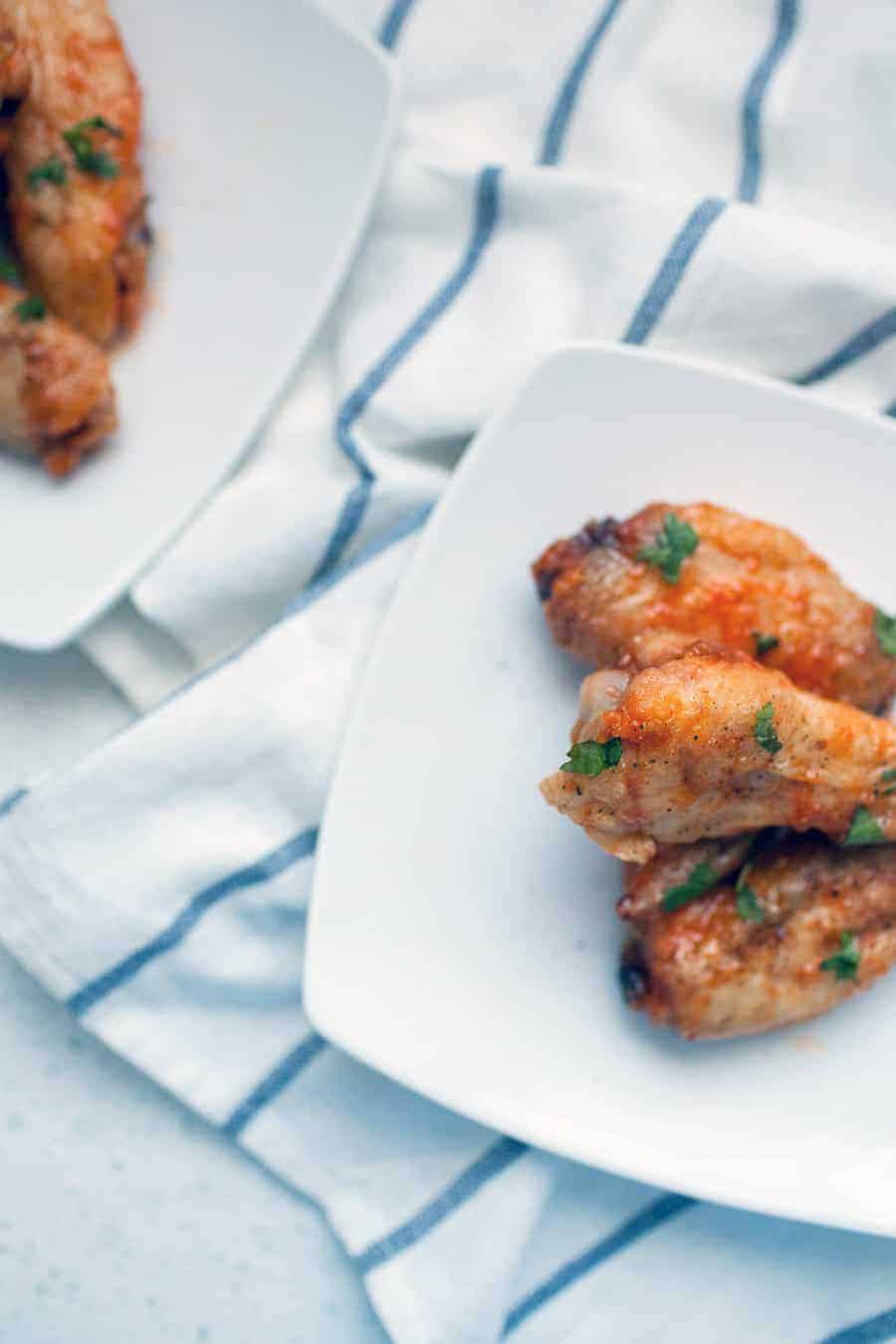 If you're looking for the perfect fall and football appetizer, these honey sriracha baked wings are your solution! They're light and crispy with a perfect blend of sweet and spicy. These can be made ahead of time and easily in bulk, making them perfect for your football and tailgating gatherings!