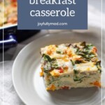 A slice of vegetarian breakfast casserole featuring vegetables and melted cheese is placed on a white plate, with the text "Vegetarian breakfast casserole" and "joyfullymad.com" shown above. Embrace mornings with this delightful recipe, reminiscent of a comforting tequila bread pudding.