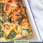 Overhead view of a vegetarian breakfast casserole in a white baking dish, featuring a golden-brown cheesy top with visible greens. Text on the image reads "Vegetarian breakfast casserole" and "joyfullymad.com." This delightful dish could pair well with tequila bread pudding for brunch.