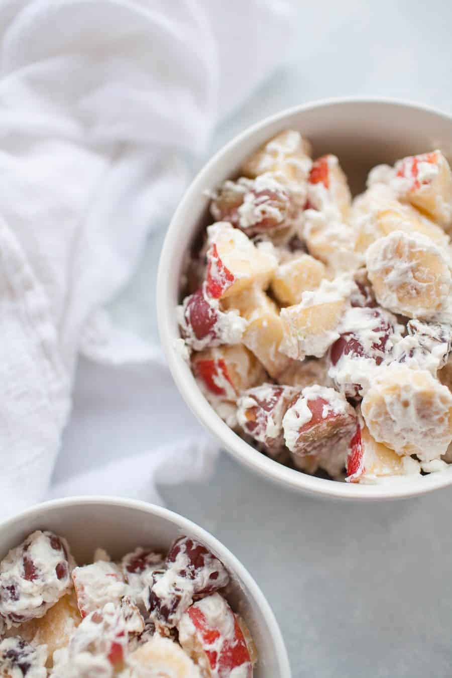 Whipped cream fruit salad is the perfect holiday side dish or dessert! It's made with fresh fruit like grapes, bananas and apples and homemade whipped cream, sweetened with a bit of honey, so this dish is perfect for the whole family. Serve with your turkey holiday dinners or as a part of your regular weeknight dinner menu.