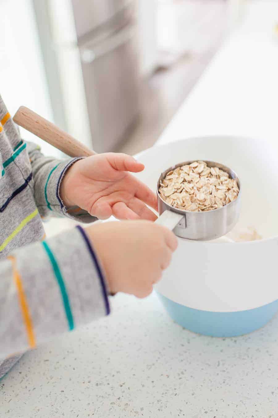 Teaching your toddler to help in the kitchen can be a daunting task, but it's one that can take away the stress of having to keep an eye on your kiddos while trying to prep dinner or a snack. Teaching your little ones about being in the kitchen can be fun and stressless with a few quick tips for cooking with toddlers!