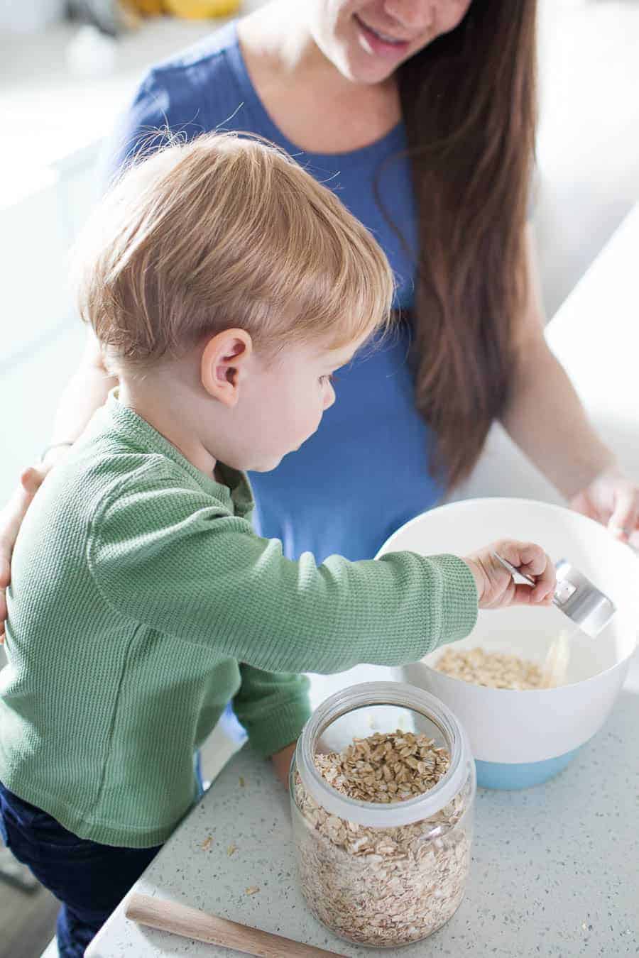 Teaching your toddler to help in the kitchen can be a daunting task, but it's one that can take away the stress of having to keep an eye on your kiddos while trying to prep dinner or a snack. Teaching your little ones about being in the kitchen can be fun and stressless with a few quick tips for cooking with toddlers!