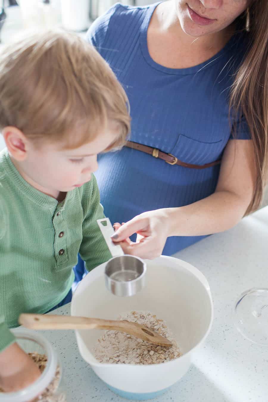 Teaching your toddler to help in the kitchen can be a daunting task, but it's one that can take away the stress of having to keep an eye on your kiddos while trying to prep dinner or a snack. Teaching your little ones about being in the kitchen can be fun and stressless with a few quick tips for cooking with toddlers!