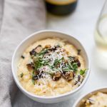 Creamy risotto with parmesan cheese and a bottle of wine.