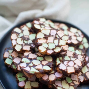 Looking for a different kind of treat to bring to a holiday get together this year? Stained Glass Window No Bake Cookies are one of the easiest desserts you can bring to a party and they're bound to be a hit! Anyone can make these no bake treats that are made with butter, mini colored marshmallows and melted chocolate chips. The mixture is rolled into logs and sliced into one inch thick cookies.?