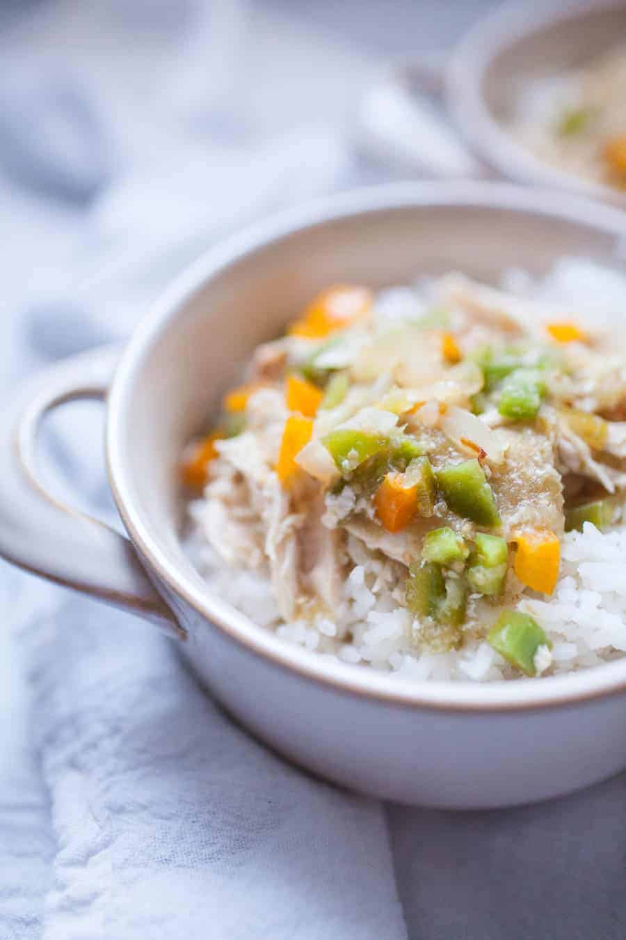 This five ingredient Salsa Verde Chicken is an easy weeknight slow cooker meal the whole family will love! It's made with jarred salsa verde, chicken, bell peppers, onions and rice and it's ready in a matter without even thinking about it.?