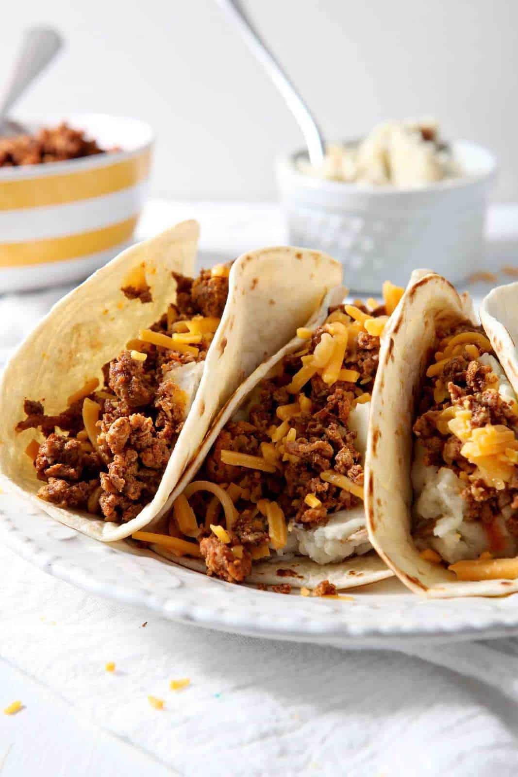 In search of the ultimate comforting breakfast? Look no farther than Mashed Potato Chorizo Breakfast Tacos! These tacos, made with store-bought chorizo and homemade mashed potatoes, are the stuff dreams are made of. They cook up quickly to create a flavorful meal! Easy to make ahead of time and freeze, these breakfast tacos are an ideal dish to bring a new mama, friends who moved, etc. Mashed Potato Chorizo Breakfast Tacos are an amazing meal!