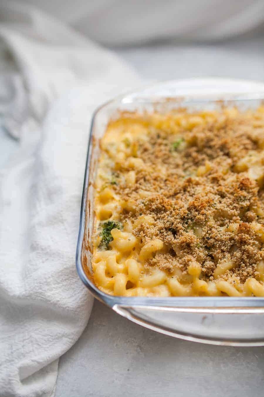 Homemade macaroni and cheese baked in a glass dish.