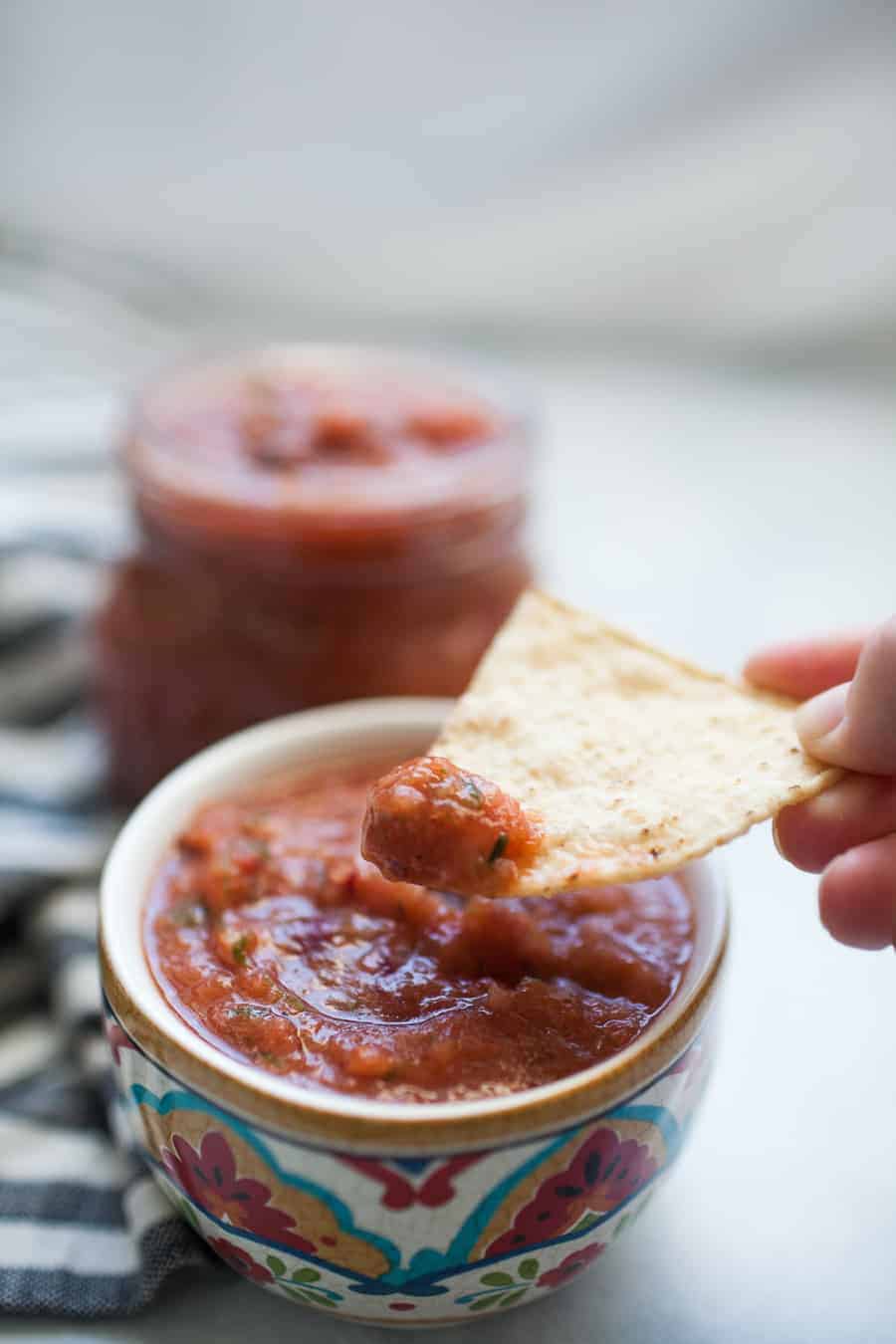 Five Minute Blender Salsa is the easiest way to enjoy fresh, delicious restaurant style salsa at home! One batch makes enough for a crowd and can be made in minutes with a blender or food processor. See how easy (and delicious) this restaurant style salsa is!