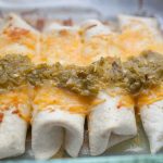 Sour Cream Chicken Enchiladas are the perfect weeknight dinner that will gather your family around the table. These enchiladas are made with flour tortillas, instead of traditionally used corn tortillas, and are stuffed with shredded chicken mixed with cream of chicken soup, sour cream, and cheese. The whole dish is topped with cheese and spicy green chile sauce! It's packed with flavor and the perfect dish for your family!?