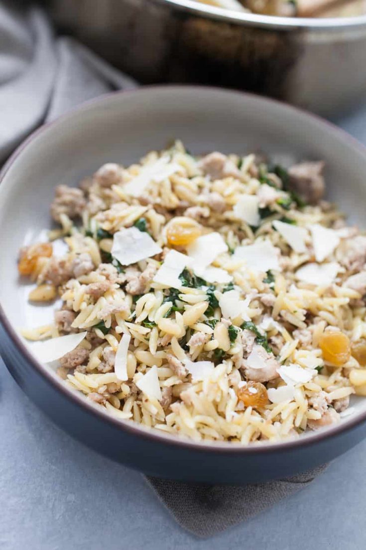 Spinach Turkey Orzo is a super easy meal that is packed with flavor for a perfect quick dinner option! This orzo dish has ground turkey, spinach, pine nuts, golden raisins and is topped with olive oil and shaved parmesan. The complexity of flavors in this dish is amazing, but you don't have to spend a long time getting this dinner together!