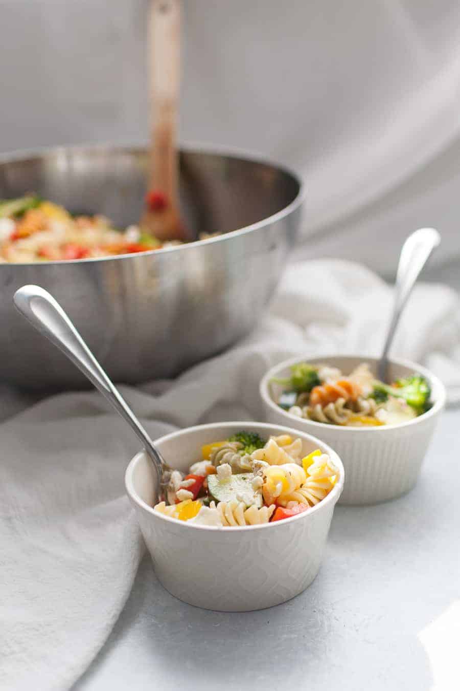 Veggie packed pasta salad is a perfect side dish for any occasion. It's great for the warmer weather for potlucks outside and perfect for brightening the colder months, too! The pasta salad is made with a mayo-free dressing and packed with vegetables like cucumbers, bell peppers, tomatoes, corn and topped with feta cheese.?