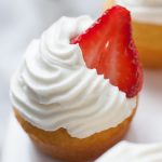 Strawberry Shortcake Cupcakes are the perfect dessert for any occasion. These cupcakes are light and fluffy and bring the experience of eating strawberry shortcake into a cupcake! Spruce up a boxed cake mix with a few add ins and your own homemade whipped cream icing that tastes just like the real thing. Top with a slice of fresh strawberry and you're ready to share these cupcakes over a cup of coffee with friends!?