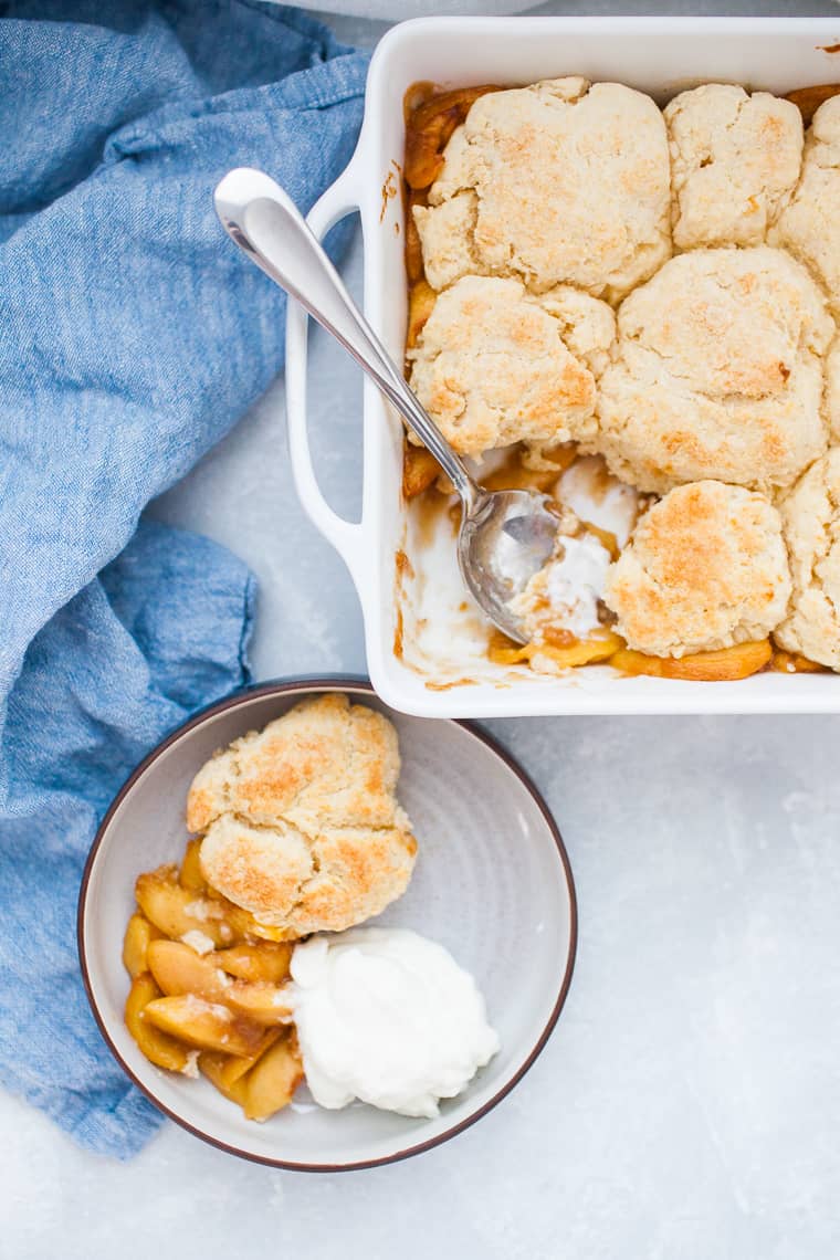 Square baking dish with peach cobbler.