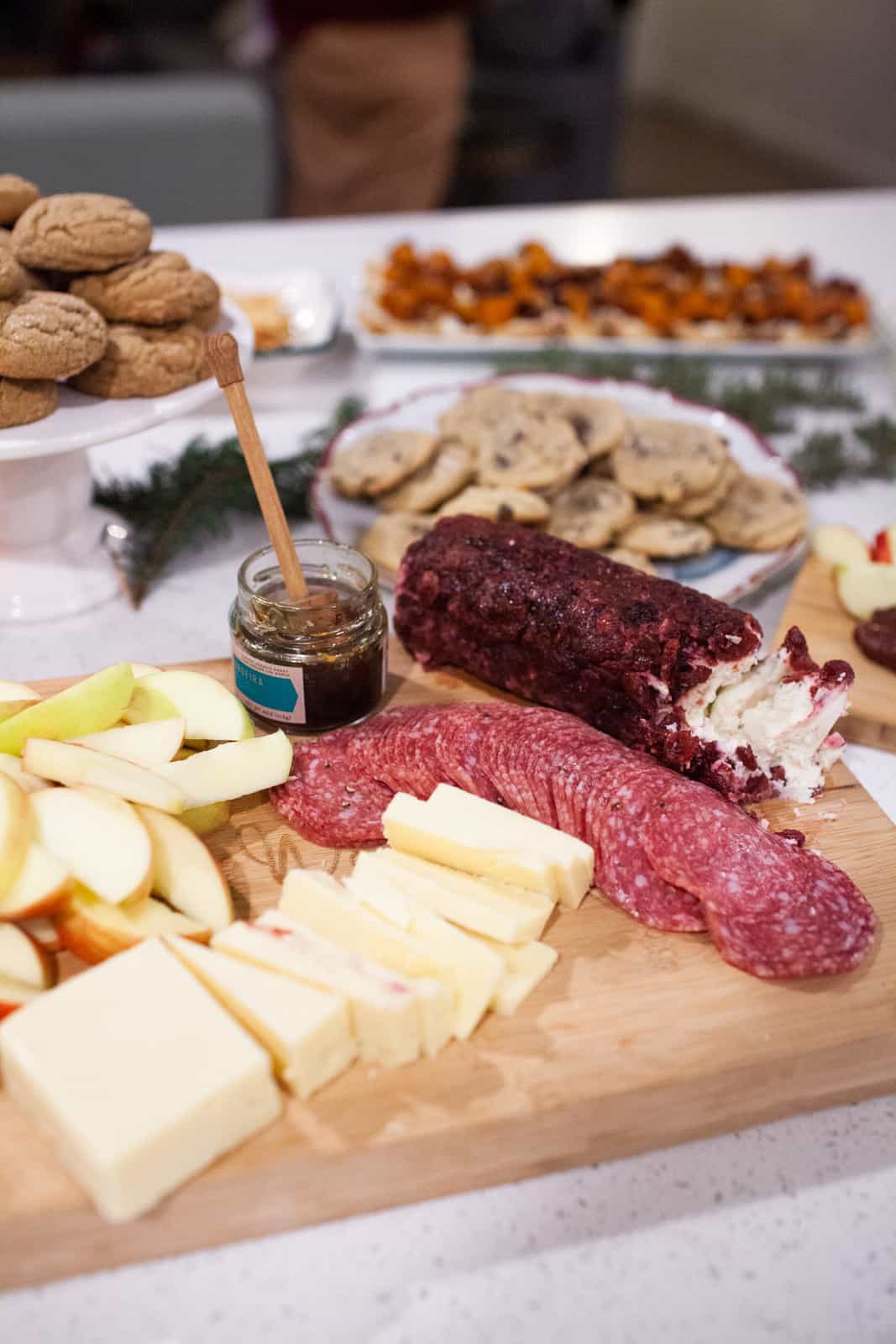 Appetizer platters on a large table at a holiday wine party