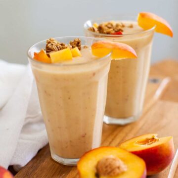 peach smoothies on a wood board