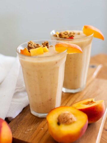 peach smoothies on a wood board