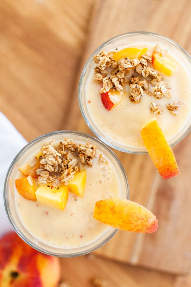 granola on top of peach smoothies