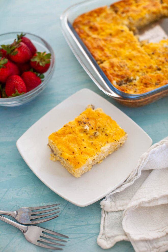 A breakfast spread including strawberries and egg casserole.