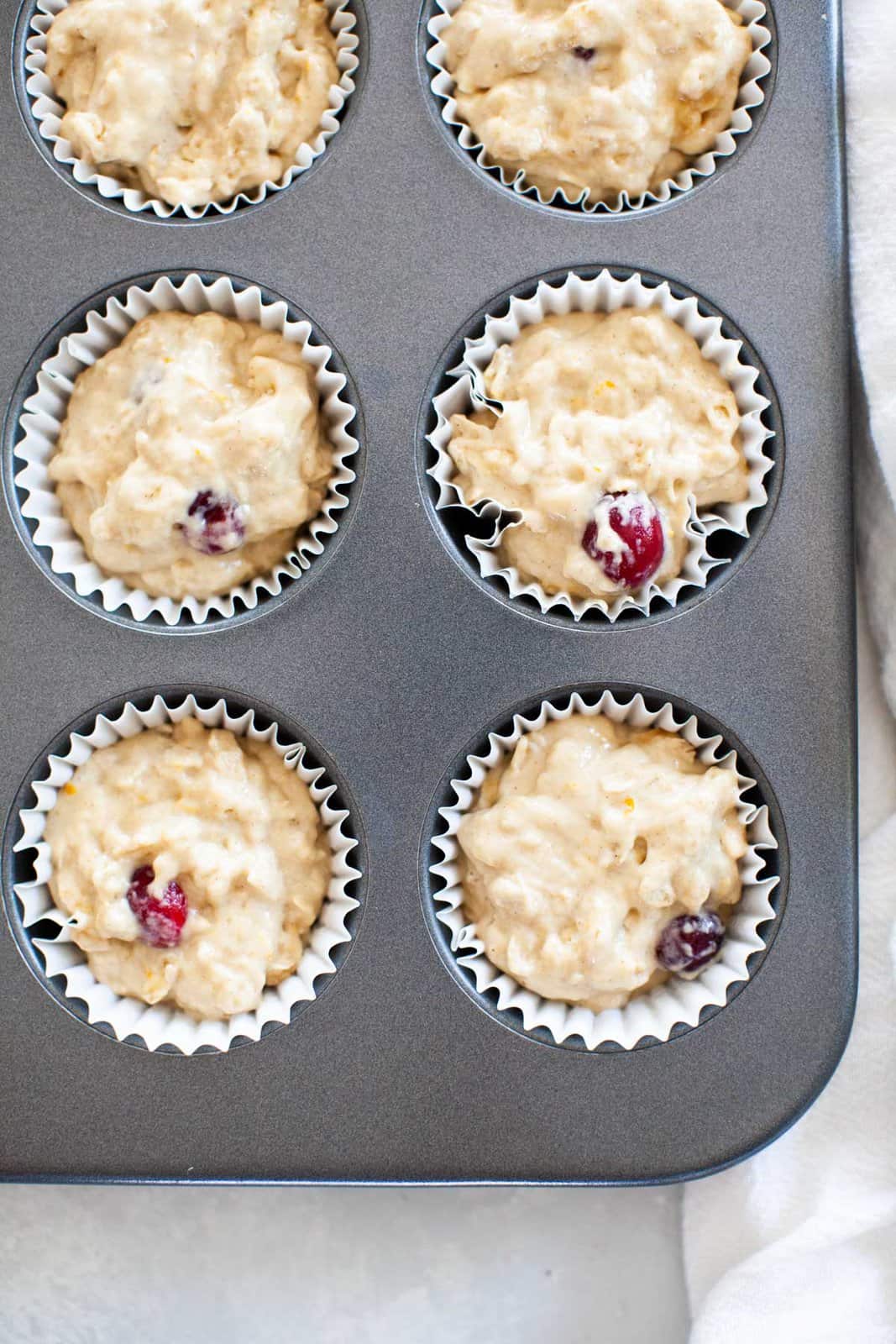 Cranberry muffin batter in baking cups
