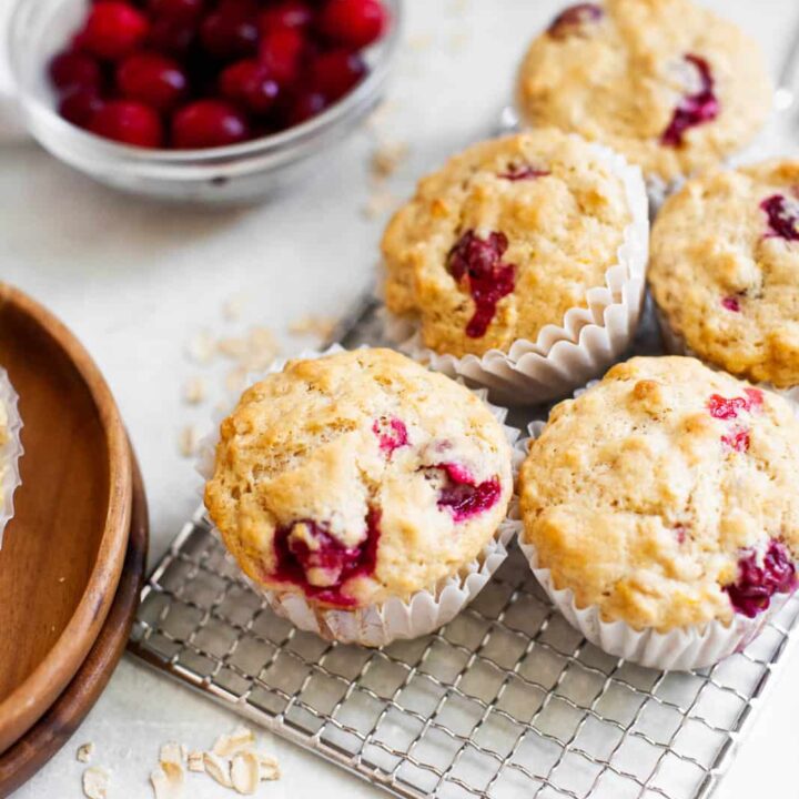 gooey cranberry muffins on a cooling rack