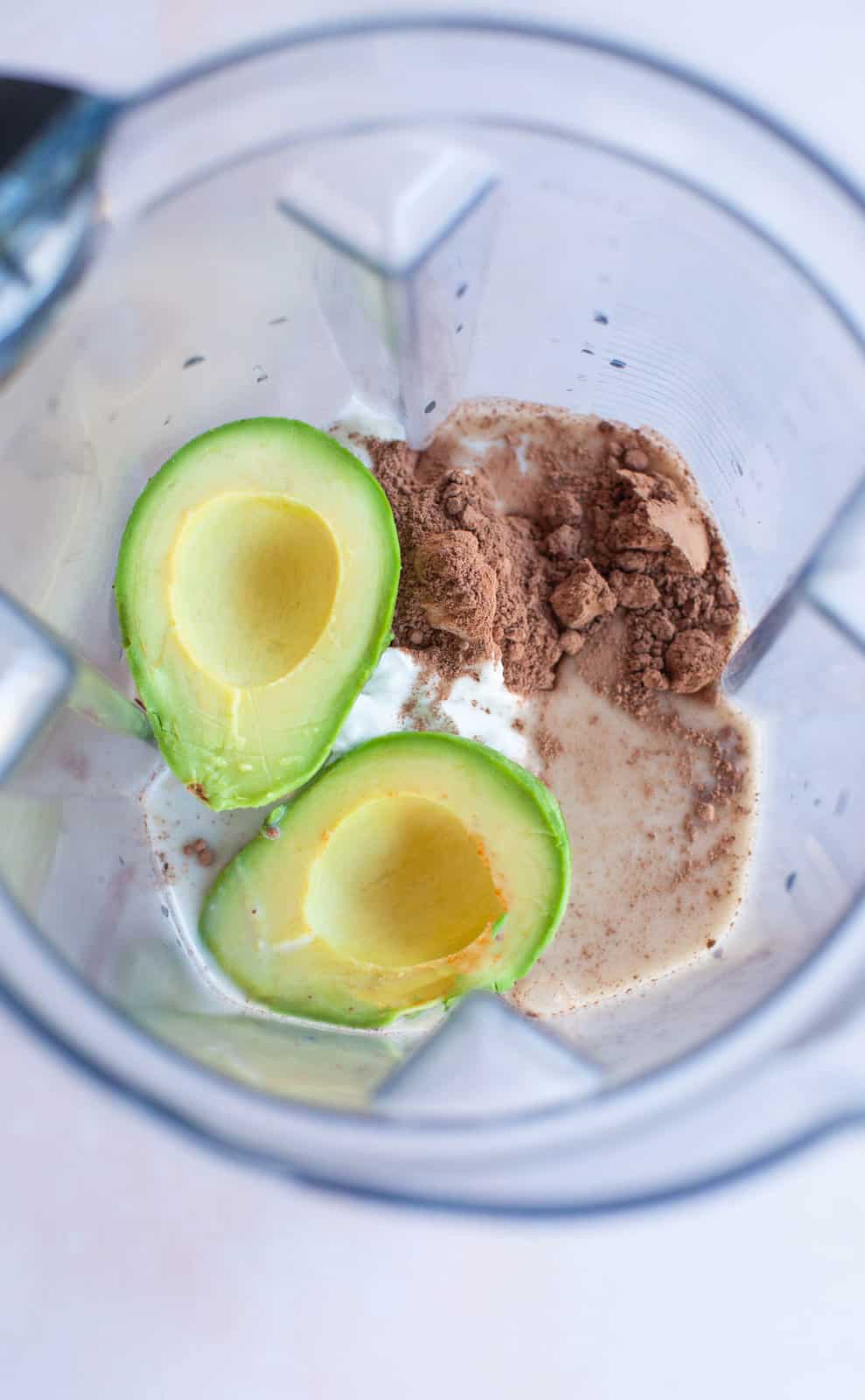avocado, cocoa powder, milk and yogurt in a blender.