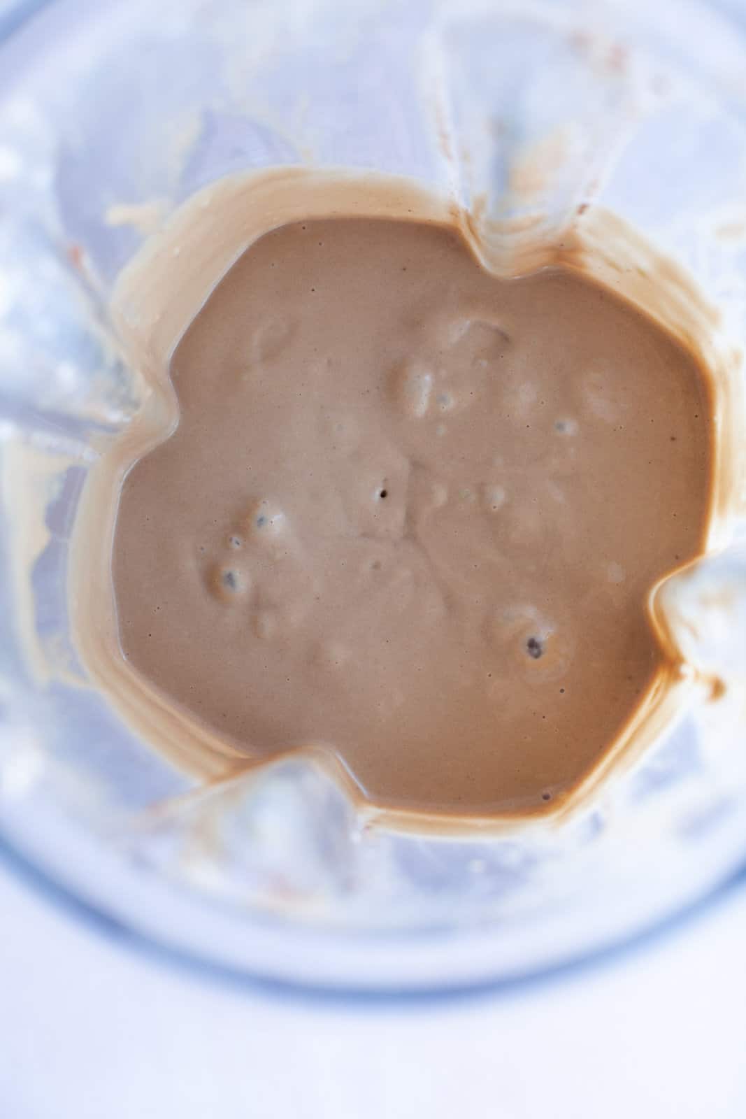 Chocolate smoothie in a blender, viewed from overhead.