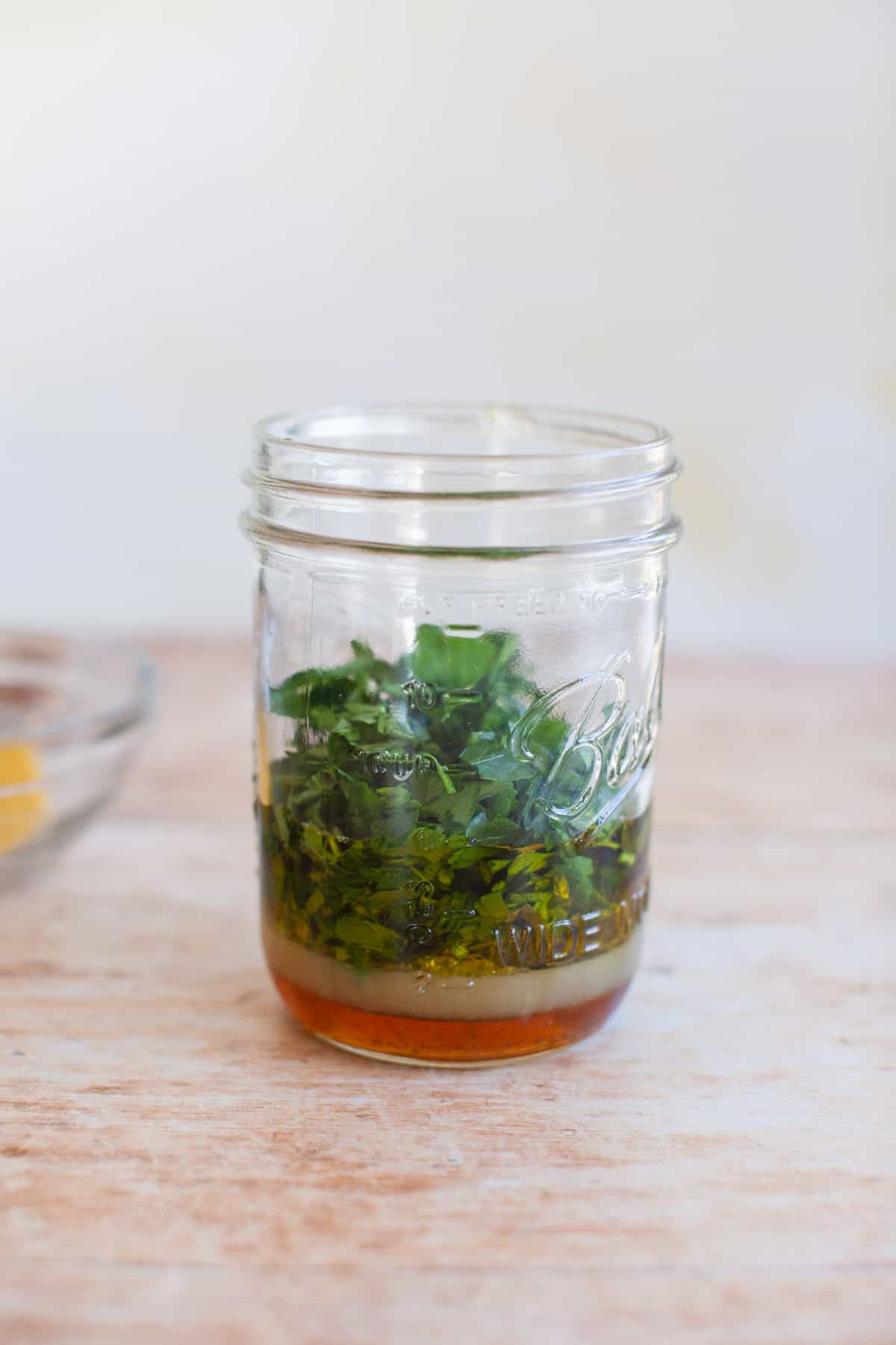 parsley leaves in a jar of marinade