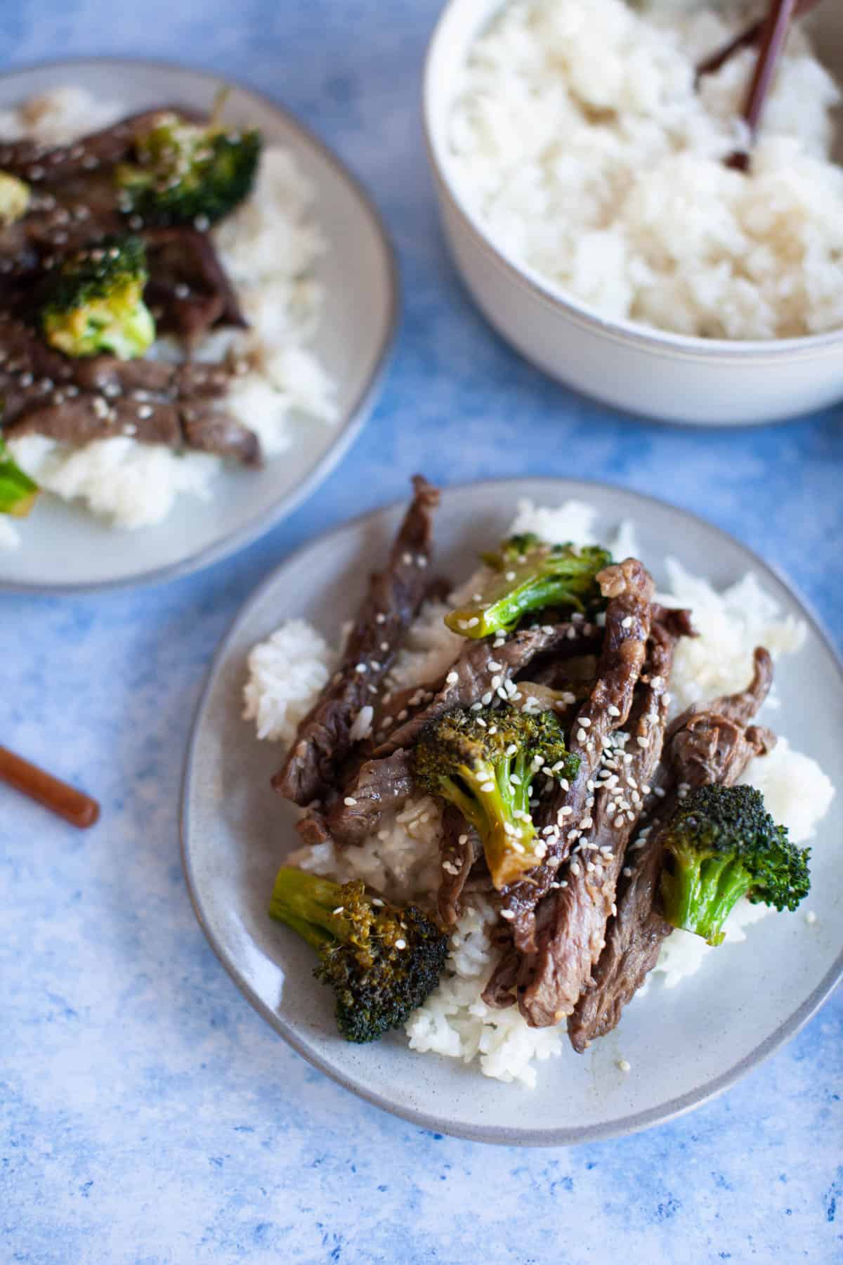 Broccoli Beef Stir Fry on a bed of white rice with sesame seeds on top