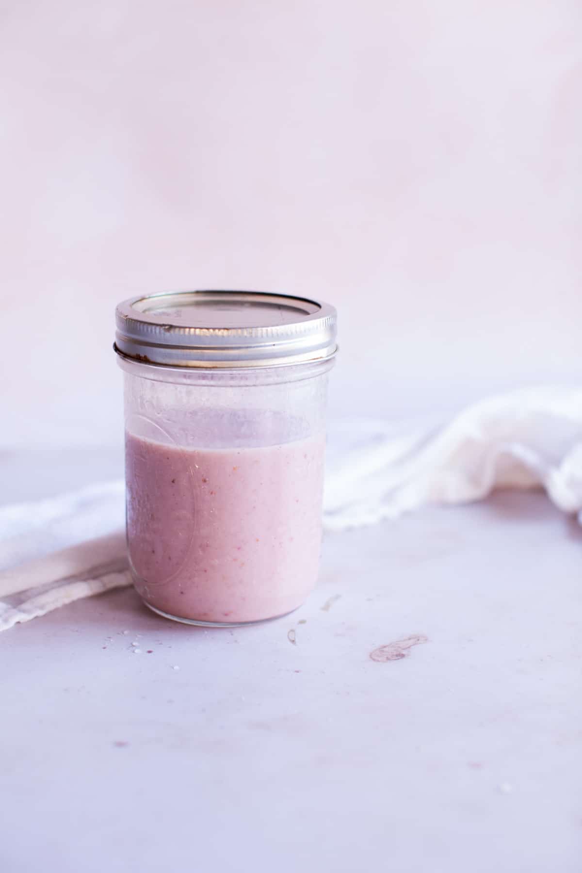 pink smoothie in a mason jar