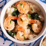 bowls of shrimp risotto on a blue tile countertop.