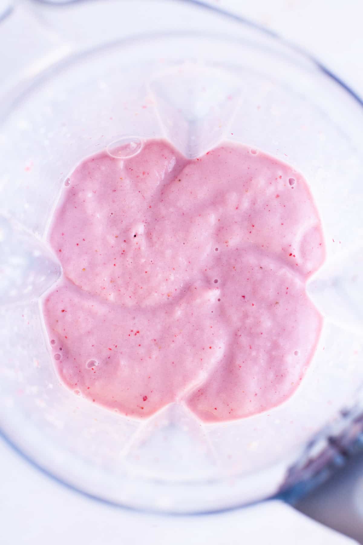 Blended strawberry smoothie in blender.