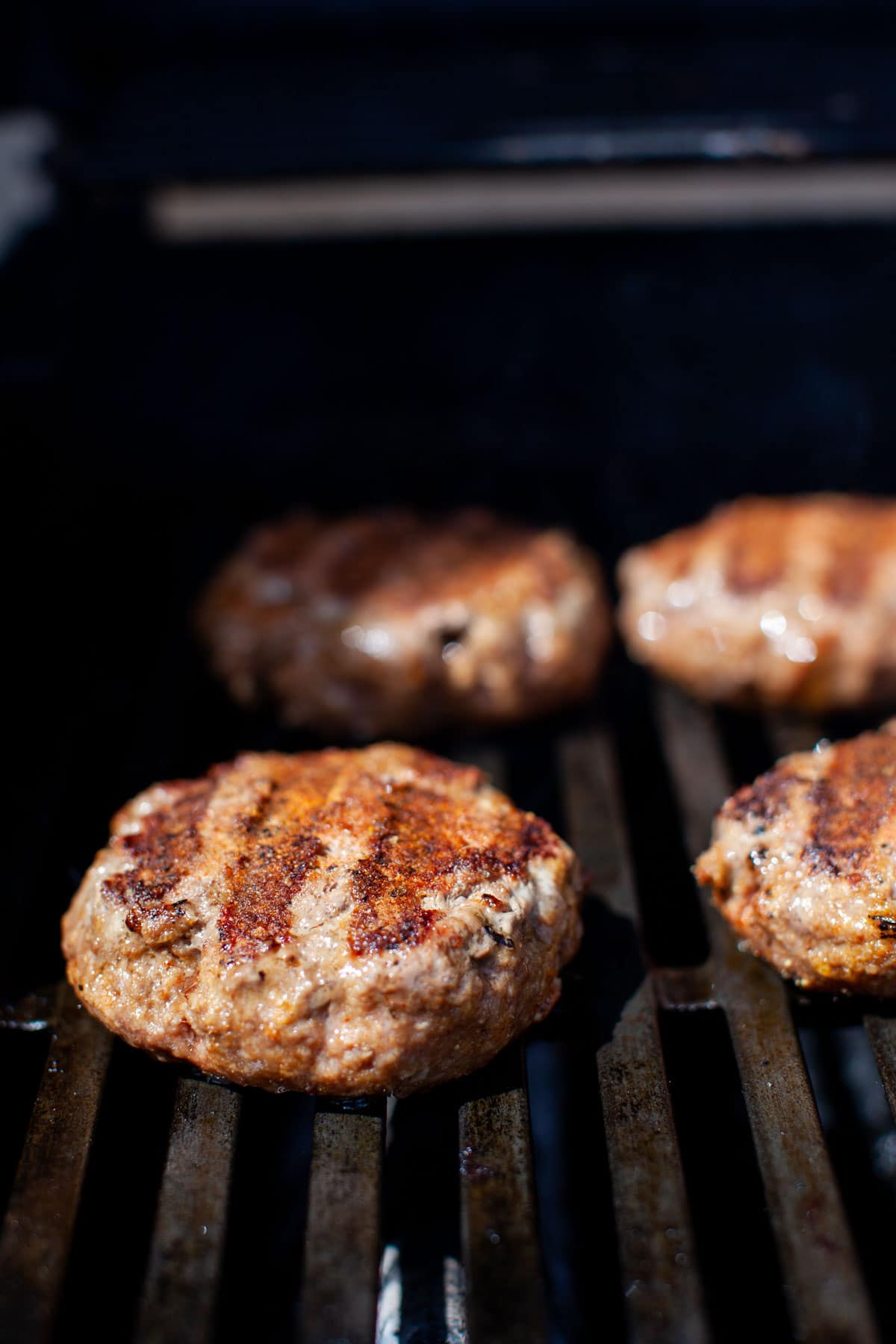 Beef burgers on the grill.