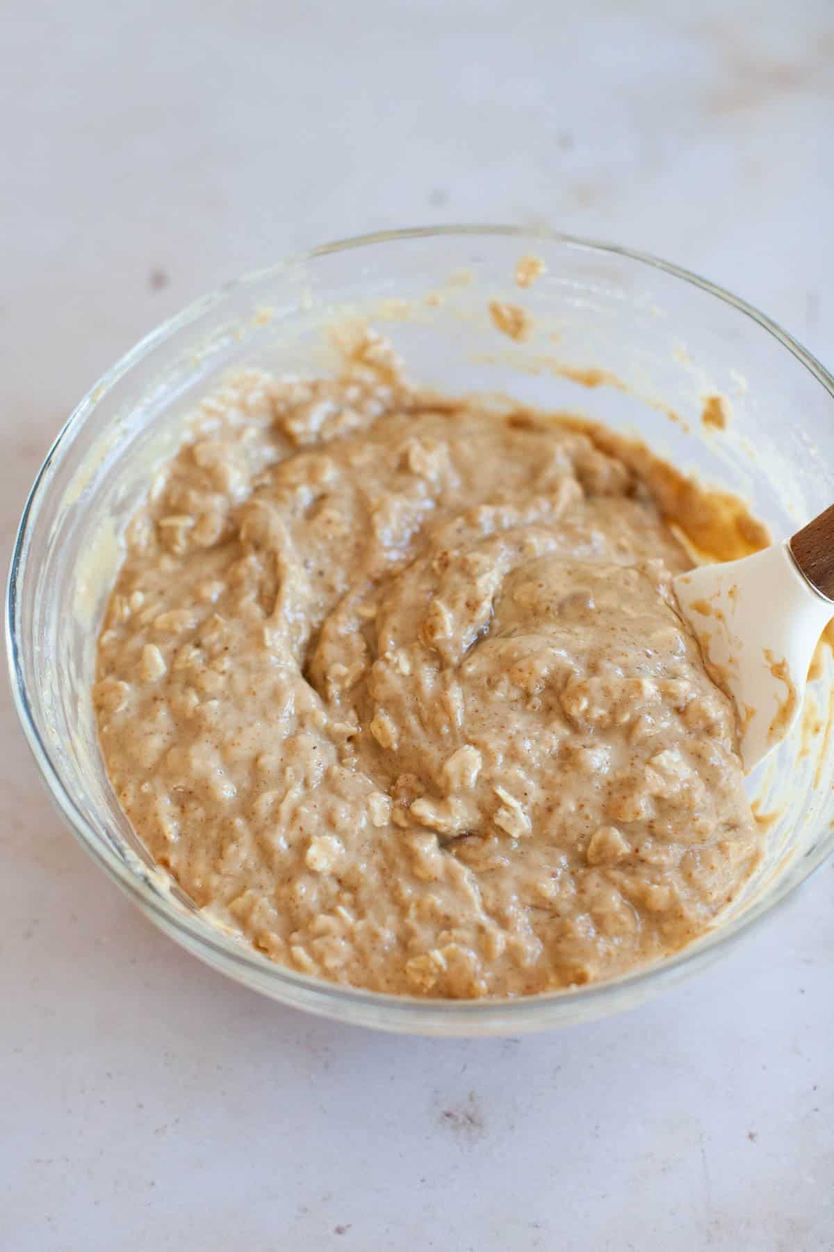 Dairy free muffin batter, mixed together in a glass bowl.