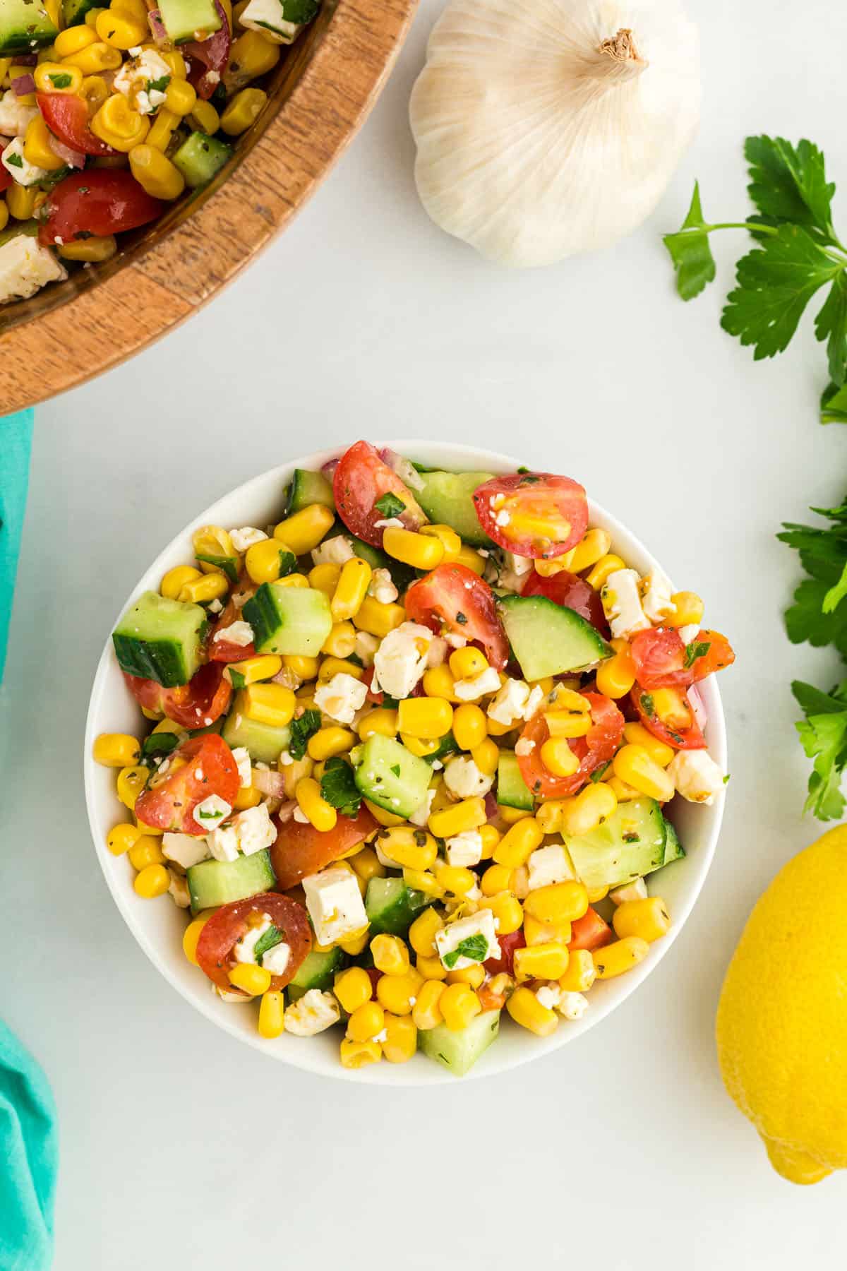 Corn salad mixed together in a white bowl.