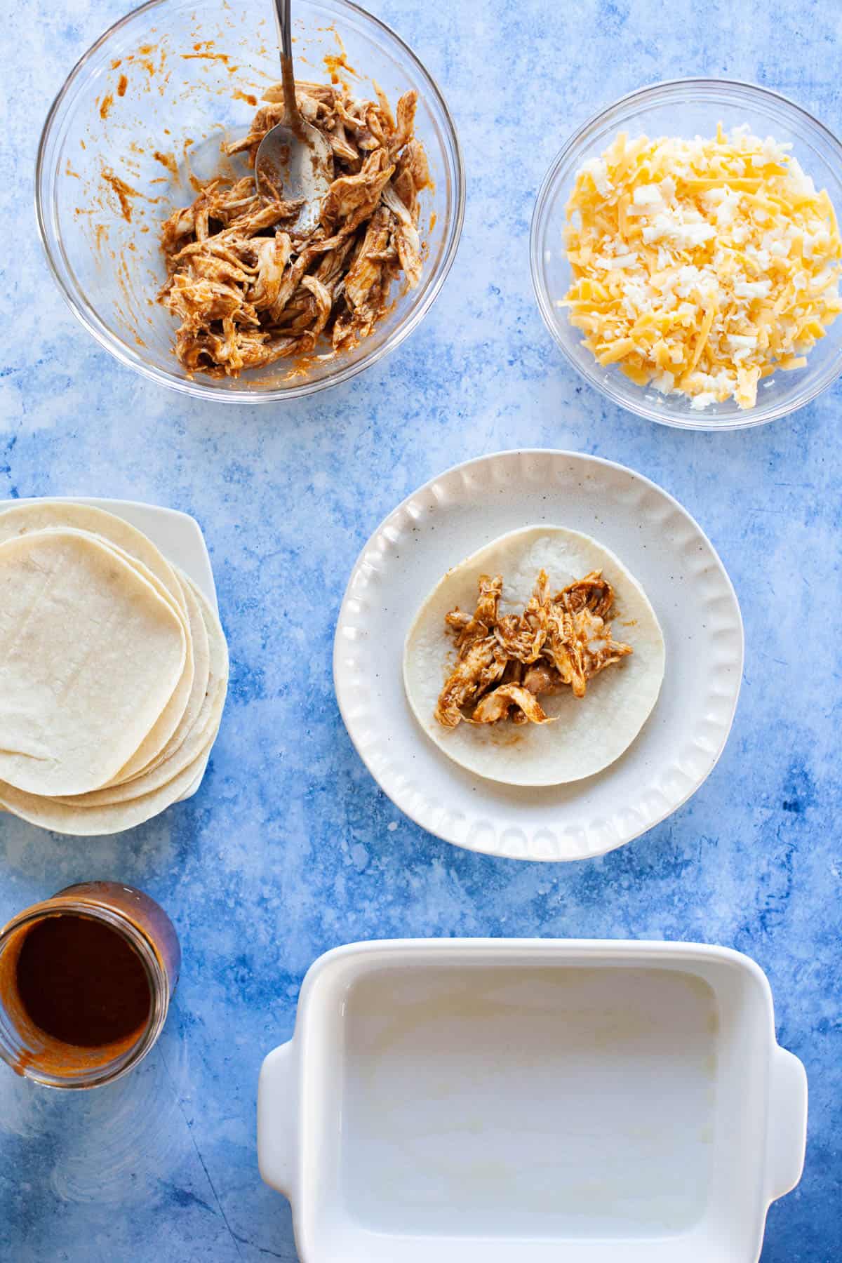 A portion of the rotisserie chicken on a corn tortilla.