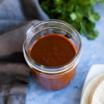 Enchilada sauce in a glass mason jar.