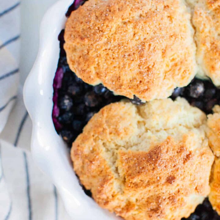 Fully baked blueberry cobbler in a pie dish.